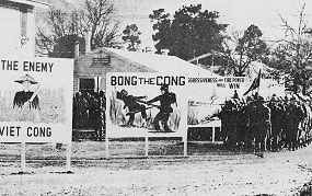 Photo shows troops on a military base being shown billboards with racist images and slogans such as "The Enemy--Viet Cong" and "Bong the Cong."